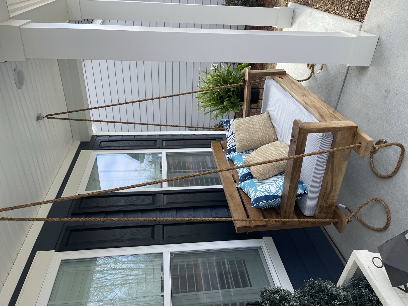 Finished bed swing with tropical pillows, hung and ready to relax
